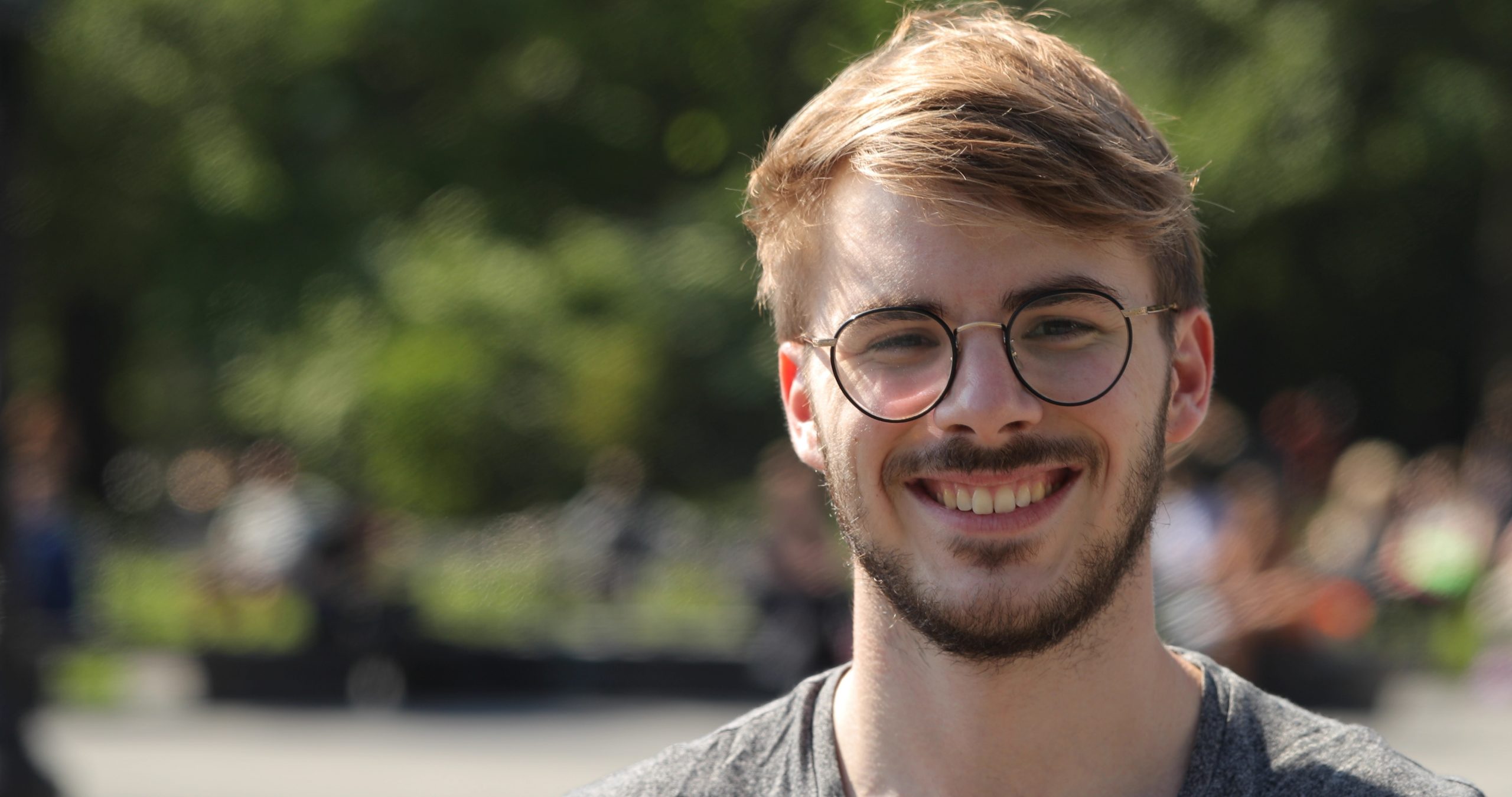 Young man in city park face portrait